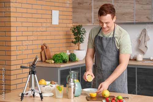 Young man recording video o...