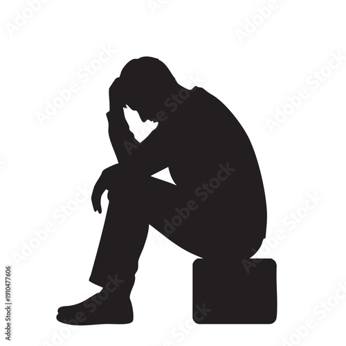 Silhouette of a depressed man sitting alone on a stool feeling hopeless
