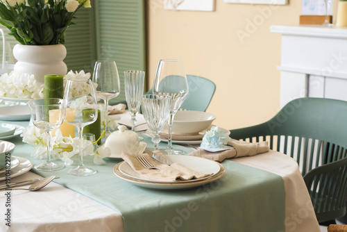 Beautiful table setting with white flowers for wedding celebration in room, closeup
