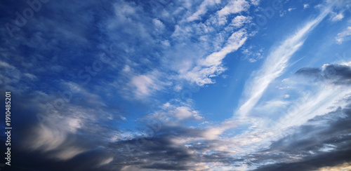 Dramatic sunset sky with wispy clouds and deep blue twilight.