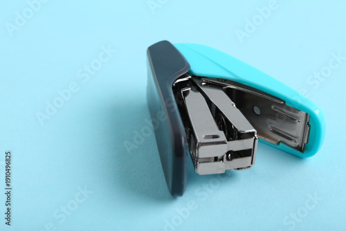 Blue stapler on color backg...