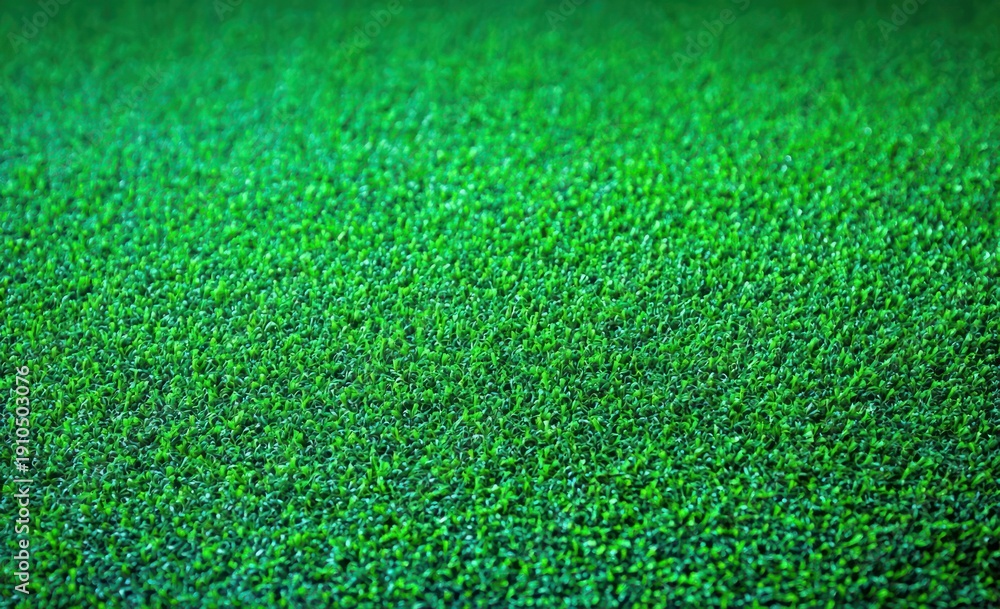 Fototapeta premium close-up of dense vibrant green grass blades forming a uniform lawn with a fresh, calming feel