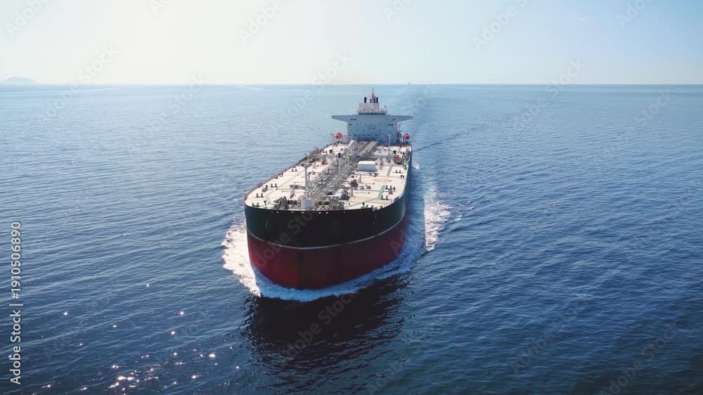 Aerial view of a crude oil super tanker ship traveling with speed over ...