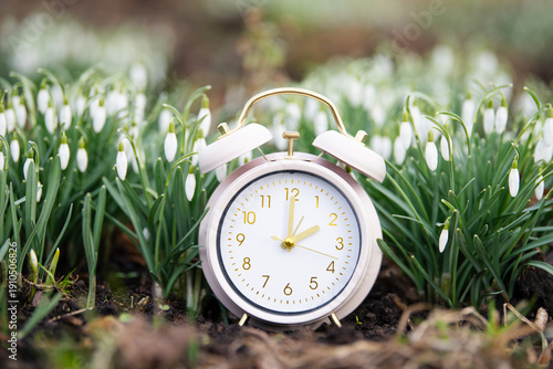 Fotografie Switch to daylight saving time in spring, summertime changeover, alarm clock wit
