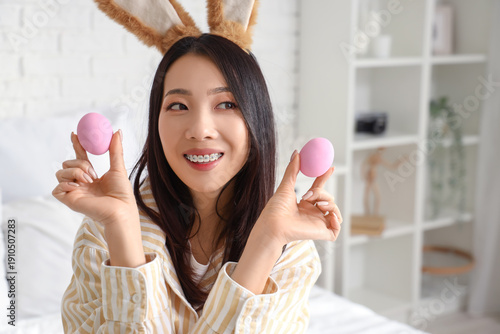 Young Asian woman with bunn...