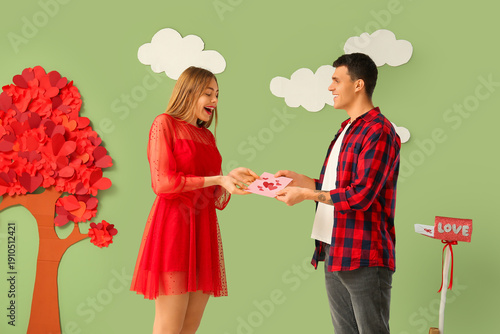 Young couple with greeting ...