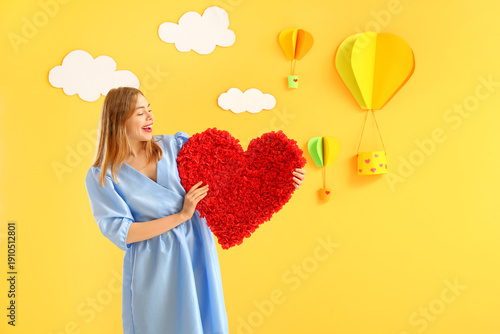 Young woman with heart near...