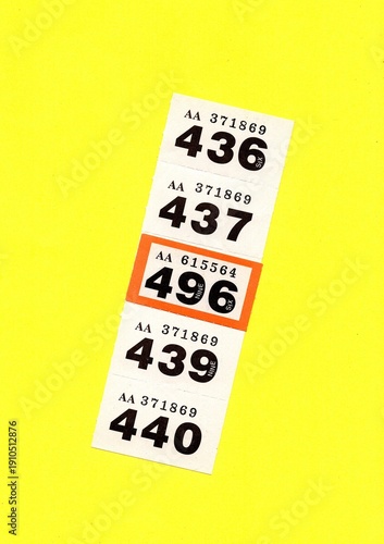 Vintage raffle tickets on a bright coloured background with one highlighted in a different colour.