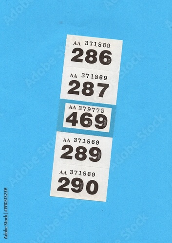 Vintage raffle tickets on a bright coloured background with one highlighted in a different colour.