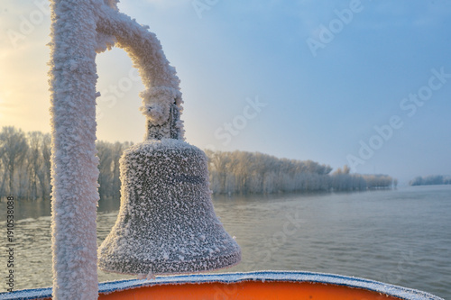 Frozen ship bell in winter time