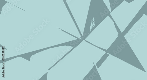 Shattered glass fragments with abstract shapes on a fractured surface viewed from above