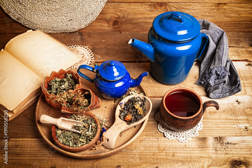 cup of herbal tea and ingredients on wooden table