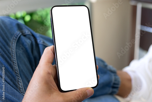 Male hand holding phone with isolated screen on jeans background