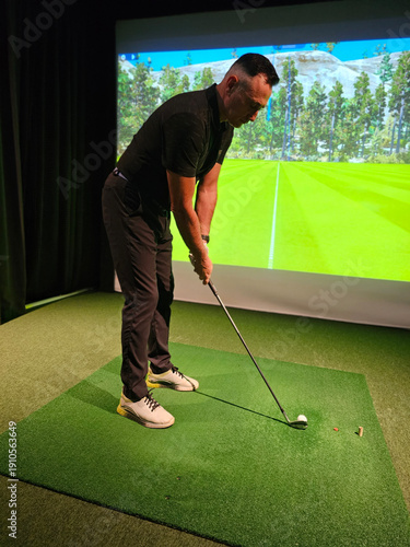 Wallpaper Mural Golf player stands on green mat in front of screen showing virtual course Torontodigital.ca