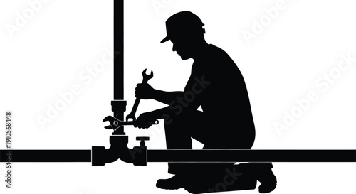 Worker in hard hat kneeling to inspect industrial valve with wrench in hand, showcasing maintenance work in a technical environment from a side view ljgnhjdmxadmlzjztgzn4gtl0qmz00im4utntiz