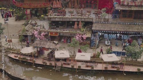 Atmospheric view of Cat Cat Village in Sapa, Vietnam, featuring traditional houses, greenery, riverside and a waterfalls setting that reflects the peaceful mountain village environment.