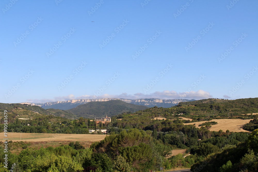 Fototapeta premium Dirt path leading toward Estella on Camino de Santiago Frances in Navarra Spain July 2024