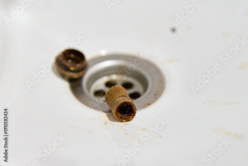 Wallpaper Mural Removal of clogged strainer filter mesh from sink drain in bright white environment Torontodigital.ca