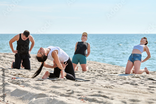 Wallpaper Mural Group yoga session on Sandy Baltic Sea beach in bright daylight Torontodigital.ca
