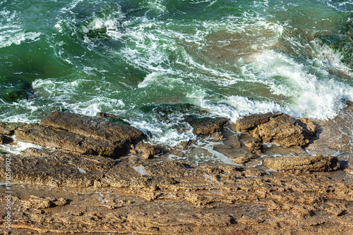  seascape background of rocky coastline on high surf windy weather