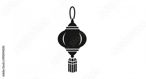 Black chinese lantern ornament with tassel hanging on a loop isolated on white background
