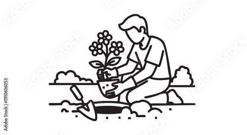 Man planting a flowering plant in the garden from a kneeling position