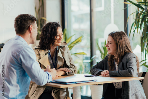Fotografie Coworkers enjoying coffee break and relaxed conversation