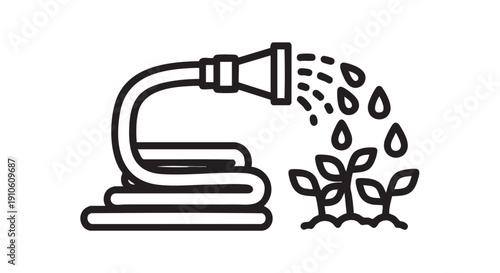 Watering can pouring water on young plants in a garden from a high angle