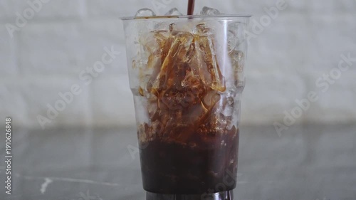 Wallpaper Mural 4K Coffee pouring over ice cubes in clear glass refreshing iced drink Minimal cafe style cold beverage concept. Torontodigital.ca