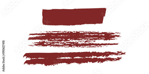 A close up view of three swatches of dark red lipstick on a white background for color comparison and makeup testing purposes