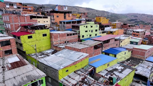 Steep High Angle View from Ascending TransMiCable Cable Car Over Dense, Colorful Slum Housing and Rooftops in Ciudad Bolivar, Bogota, Colombia.