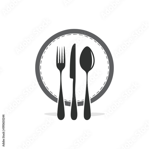 A shiny stainless steel cutlery set featuring a fork, spoon, and knife isolated on a white plate for a restaurant dinner table setting