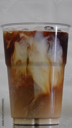 Wallpaper Mural 4K footage vertical video close up Iced coffee in clear glass with milk swirling into espresso marble patterns Refreshing cold drink, Concept minimal cafe style beverage background. Torontodigital.ca