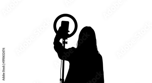 Woman Taking Selfie with Ring Light Setup

This image illustrates a woman capturing a selfie using a smartphone mounted within a ring light setup. The silhouette style emphasizes content creation, soc