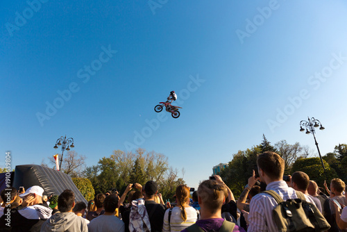  A crowd of spectators watching an extreme motorcycle jump show in Almaty
