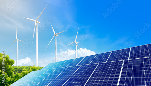 Photos Solar panels with wind turbine on blue sky
