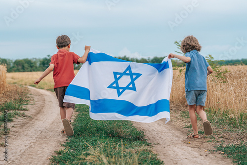 Картината върху платно Happy Israeli Jewish Little Boys Runs With Israel National Flag