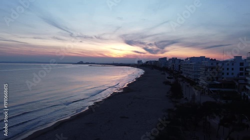 Panoramic view of the navigable canals in the Santa Margarita district of Roses, Spain. Showcasing luxury apartments with boat moorings, turquoise waters, and vibrant Mediterranean summer lifestyle.
