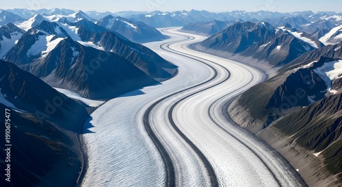 Winding glacier valley surrounded by snow capped mountains