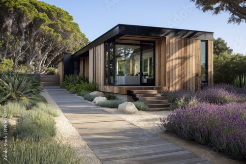 A contemporary house gracefully rests amid a vibrant garden brimming with a variety of plants and colorful flowers. It's situated near tall.