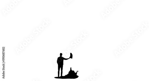 Silhouette of a man taking a photo of a small dog on the ground