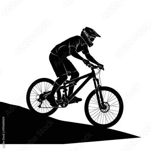 Silhouette of a mountain biker riding downhill on a slope