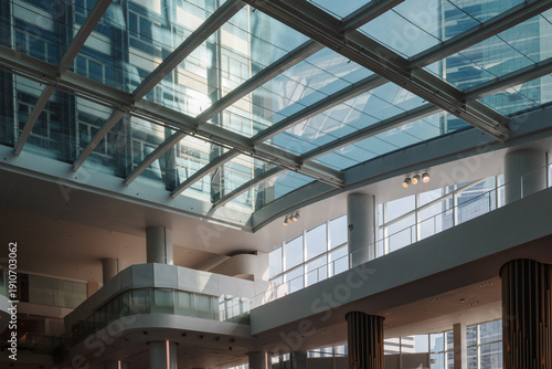 Tableau sur toile A detailed low-angle view looking through a large glass skylight at a contemporary multi-story office building