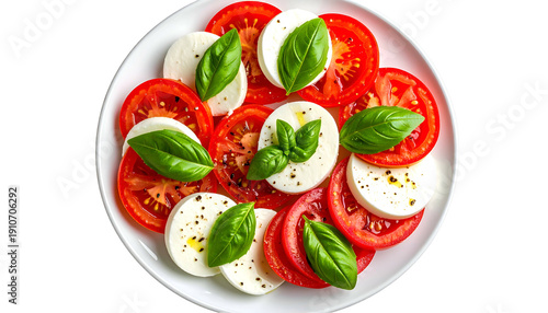 Overhead view of a caprese salad on white plate with mozzarella, tomatoes & basil (1)