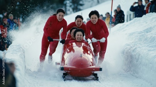 Group of Japanese women in red suits pushing a bobsled with intensity