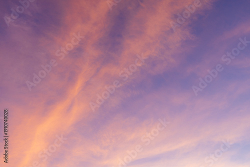 Fényképezés Dreamy Pastel Sunset Sky with Wispy Cirrus Clouds,A breathtaking view of a twilight sky filled with delicate, wispy cirrus clouds painted in shades of soft pink, orange, and deep purple