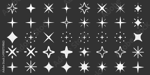 Collection of sparkling starbursts and glitter elements on a dark background