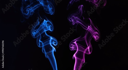 Beautiful vibrant swirling blue and purple smoke trails moving upward in a dark studio setting creating an elegant abstract background design element ,dramatic ,steam ,concept