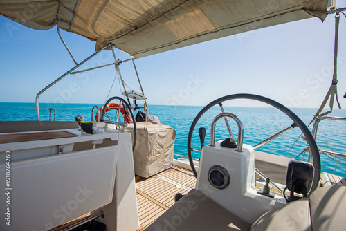 Wallpaper Mural Closeup detail view showing helm bridge on luxury sailing yacht boat with steering wheel and blue ocean background Torontodigital.ca