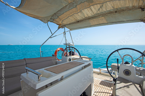 Wallpaper Mural Closeup detail view showing helm bridge on luxury sailing yacht boat with steering wheel and blue ocean background Torontodigital.ca
